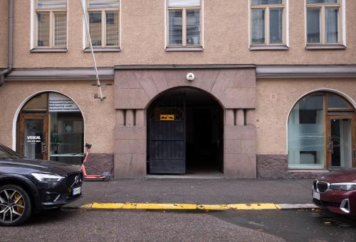 a car parked in front of a building with a door at 2ndhomes Bright & Modern 1BR Home in Ullanlinna in Helsinki