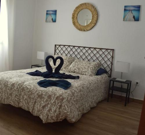 a bedroom with a bed with two towels on it at Mirador de Sotavento Apartment 8206 in Costa Calma