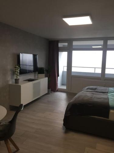 1 dormitorio con 1 cama, TV y mesa en Modern eingerichtetes Apartment Nähe Hauptbahnhof, en Brunswick