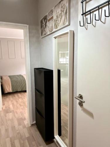a door with a mirror and a dresser in a room at Buer City Apartment mit Balkon in Gelsenkirchen