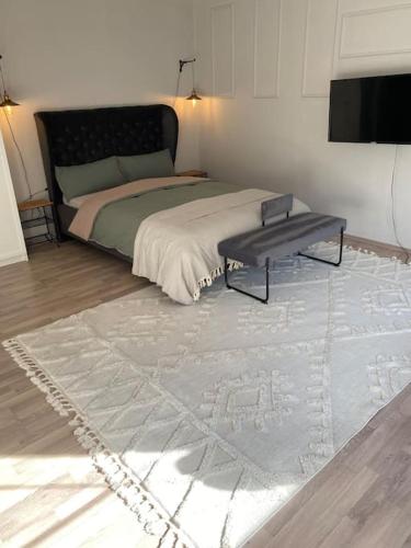a bedroom with a bed with a table and a rug at Buer City Apartment mit Balkon in Gelsenkirchen