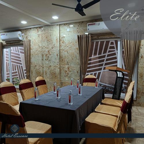 a meeting room with a table and some chairs at Hotel ESSENCE in Vellore