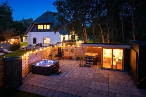 a backyard with a hot tub and a house at The island life Texel - Wellness in De Koog