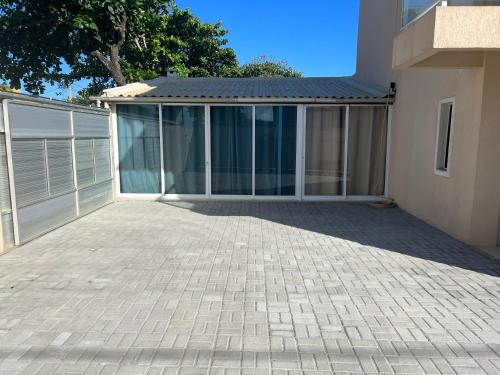 a house with a large patio in front of it at Sol de Bora Bora 101 in Salvador