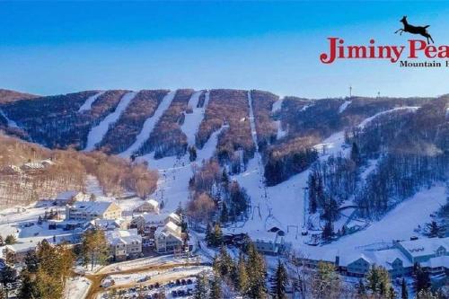 a person is flying over a snow covered mountain at Unique Yeti-Theme Ski On Off Suite Jiminy-Sleeps 4 in Hancock