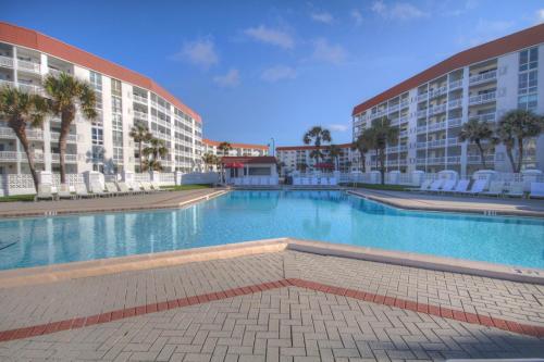 a large swimming pool in front of two buildings at El Matador 420 - Beautiful views of the Gulf and pool in Fort Walton Beach