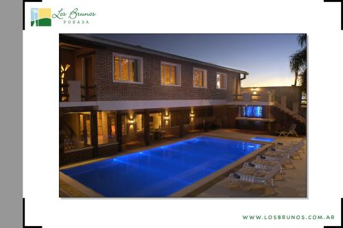 a swimming pool in the backyard of a house at Los Brunos Posada in Reconquista