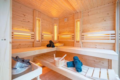 a sauna with two benches in a wooden cabin at The island life Texel - Wellness in De Koog