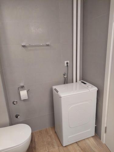 a white bathroom with a toilet and a sink at Dolce vita 1 in Belgrade