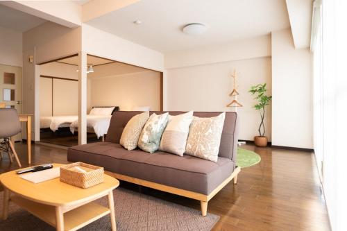 a living room with a couch and a table at RIVER WEST Hiroshima 302, 305, 306 - Vacation STAY 54100v in Ōsukachō