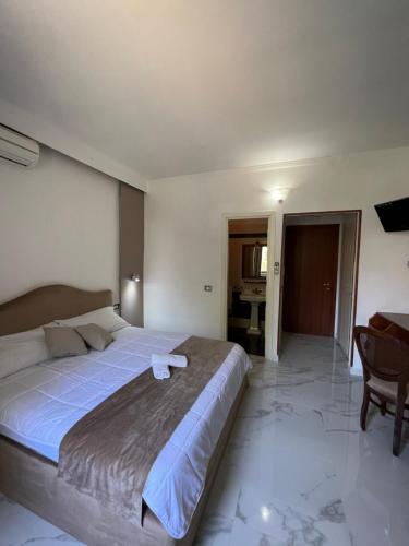 a bedroom with a large bed and a desk at Villa Edelweiss in Bacoli