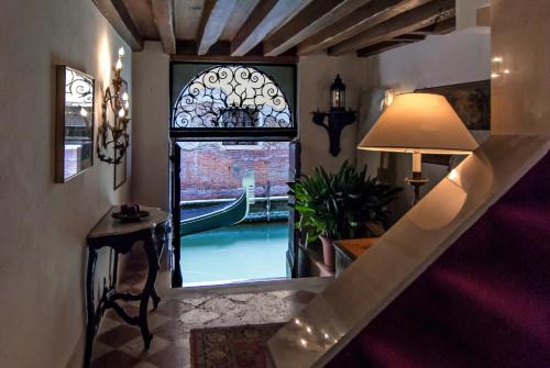 a room with a staircase and a window with a canal at Hotel Bel Sito e Berlino in Venice