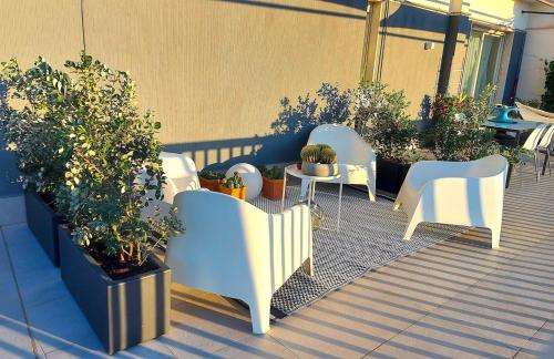 a patio with chairs and tables and potted plants at Gebel Grin in Palermo