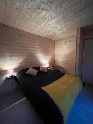 une chambre avec un lit avec deux lampes dessus dans l'établissement Chalet 1 contemporain dans son écrin de verdure, à Montauban