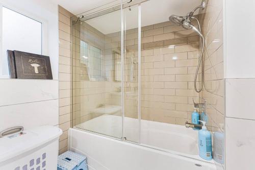 a bathroom with a shower and a tub and a sink at Amazing House In The Heart Of Vancouver DT/YVR/UBC in Vancouver