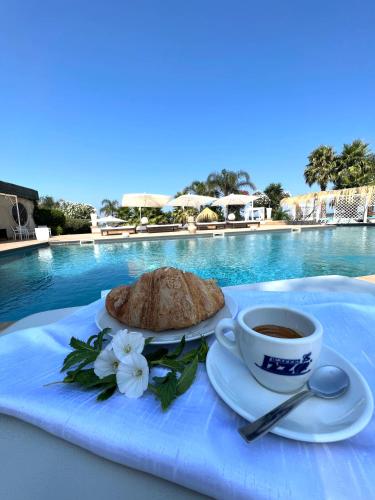 a table with a cup of coffee and a pie at Villa Edelweiss in Bacoli