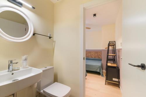 a bathroom with a sink and a mirror at Hostal Evocare Madrid in Madrid