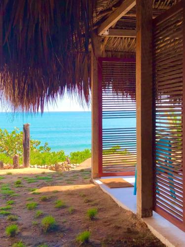 a building with a view of the ocean from a beach at Acuarela del Mar in Dibulla