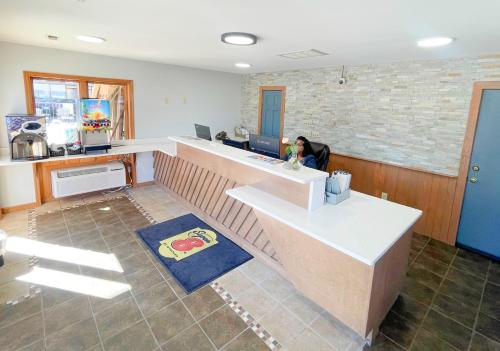 an office with a person sitting at a desk at Super 8 by Wyndham Pigeon Forge Downtown in Pigeon Forge