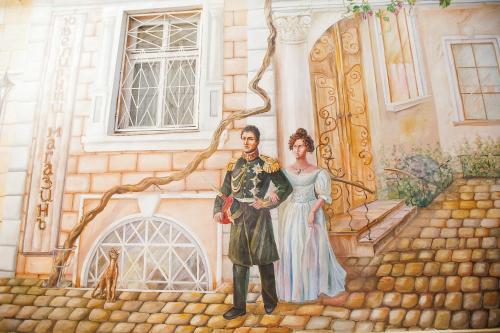 a painting of a man and woman standing in front of a building at Premier Geneva Hotel in Odesa