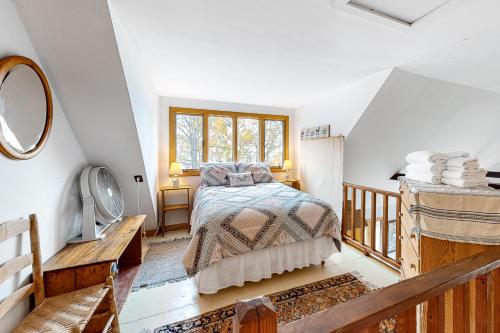 a bedroom with a bed and a window at The Bird's Nest in Isle la Motte