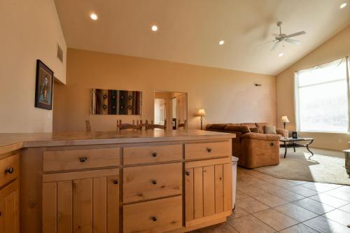 a kitchen with a sink and a living room at Rim Village M4 in Moab