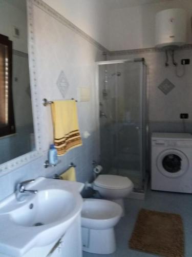 a bathroom with a sink and a toilet and a shower at appartamento in villa splendente in Castellammare del Golfo