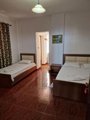 a bedroom with two beds and a hallway at Hotel Restaurant Savoja in Pogradec
