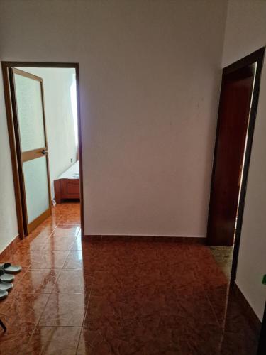 an empty room with a door and a tile floor at Hotel Restaurant Savoja in Pogradec