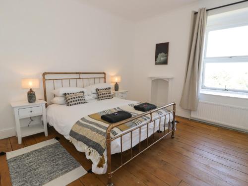 a bedroom with a bed and a large window at Bodorgan Inn in Bodorgan