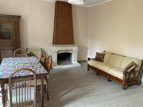 a living room with a couch and a table and a fireplace at Dimora storica don Michele in Castelpagano