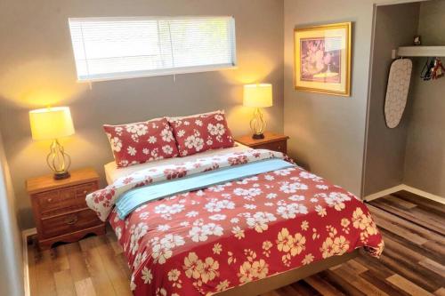a bedroom with a bed and two lamps and a window at Cheerful 3-BR home near Downtown Dayton, Wright Patterson AFB and Airport in Dayton