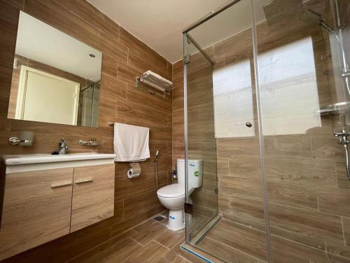 a bathroom with a toilet and a glass shower at Astoria in Casablanca