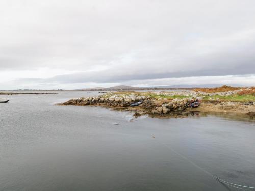 a group of rocks on the shore of a body of water at Aras Iosgan in Carraroe