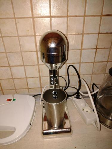 a coffee maker sitting on a counter next to a toilet at Periklis House in Ixia