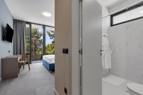 a bathroom with a shower and a bedroom at Kuk Oaza Luxury Villas in Makarska