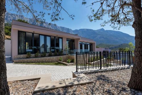 a house with a view of the mountains at Kuk Oaza Luxury Villas in Makarska