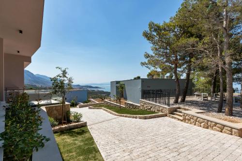a view of a patio with trees and a building at Kuk Oaza Luxury Villas in Makarska