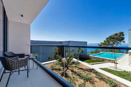 a balcony with a view of a swimming pool at Kuk Oaza Luxury Villas in Makarska