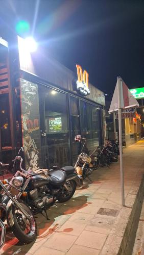 a row of motorcycles parked in front of a building at Periklis House in Ixia