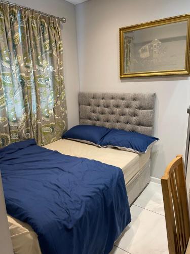 a bedroom with two beds and a picture on the wall at The Mews in Erith