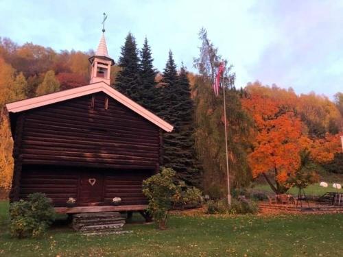 a small wooden building with a steeple on top of it at Skjeggestad Gjestehus in Ringebu