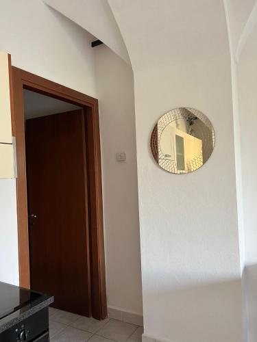 a mirror hanging on a wall next to a door at LakeView LakeComo, CIPRESSO 7, 4Seasons, Terrace, 30m to Lake! by STAYHERE-LAKECOMO in Acquaseria