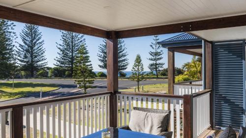 a screened porch with a view of a golf course at Ocean Spirit, 1 - 89 Yamba St in Yamba