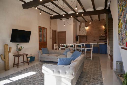 a living room with two couches and a kitchen at El mas allà in Chulilla