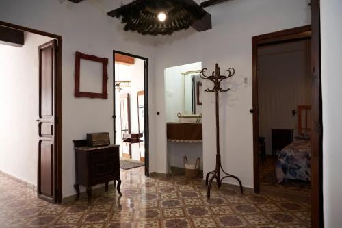 a room with white walls and a room with a mirror at El mas allà in Chulilla
