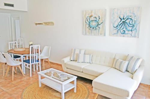 a living room with a couch and a table at Apartamento con vistas al Mar in Port de la Selva