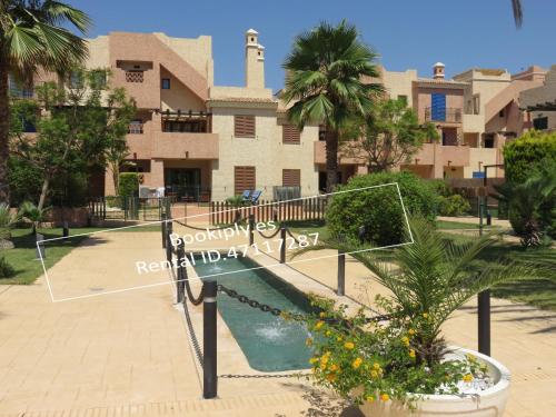 a resort with a slide in front of a building at Kasbah del Puerto Rey Precioso Bajó in Playas de Vera