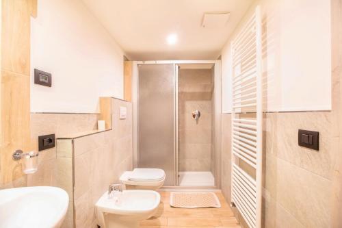 a bathroom with a shower and a toilet and a sink at Chalet Osmar Appartamento 2 in Campitello di Fassa