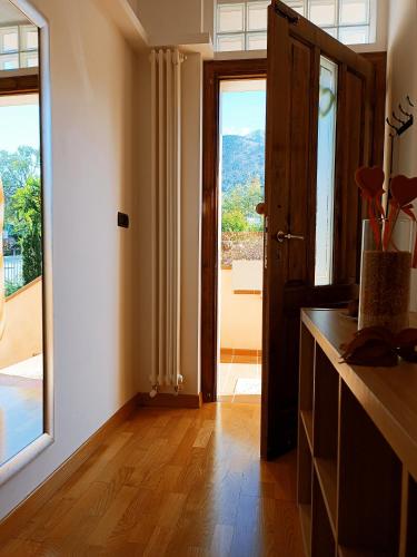 a kitchen with a large window and a door with a view at La casa di Panfilo in Sulmona